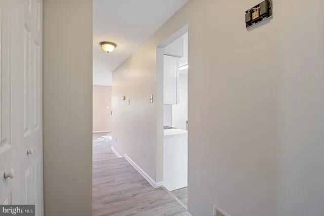 a view of a hallway with wooden floor