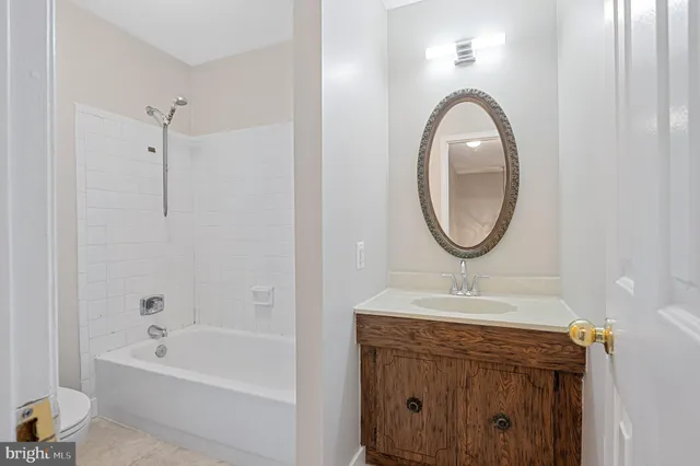 a bathroom with a sink a mirror and a bathtub
