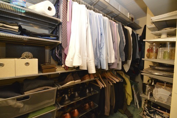 146 Marble Street, Unit 211 Stoneham, MA 02180 - Photo 15 of 20 a view of walk in closet with clothes and shoes