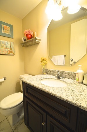 146 Marble Street, Unit 211 Stoneham, MA 02180 - Photo 19 of 20 a bathroom with a granite countertop toilet sink and mirror