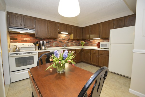 146 Marble Street, Unit 211 Stoneham, MA 02180 - Photo 3 of 20 a kitchen with a stove a sink and a refrigerator