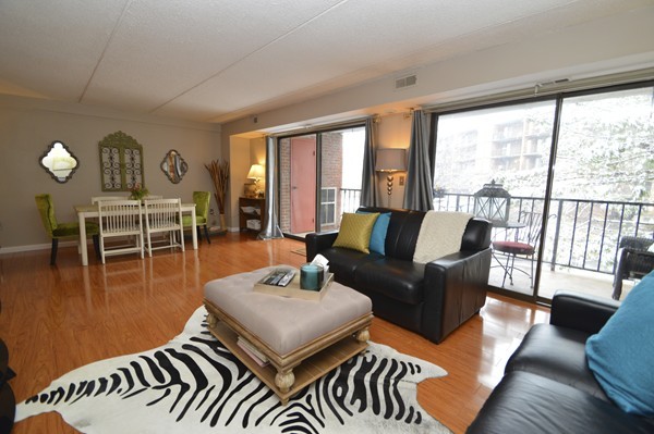 146 Marble Street, Unit 211 Stoneham, MA 02180 - Photo 5 of 20 a living room with furniture wooden floor and a large window