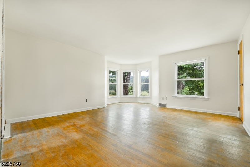 131 Karrville Road Port Murray, NJ 07865 - Photo 16 of 23 an empty room with wooden floor and windows