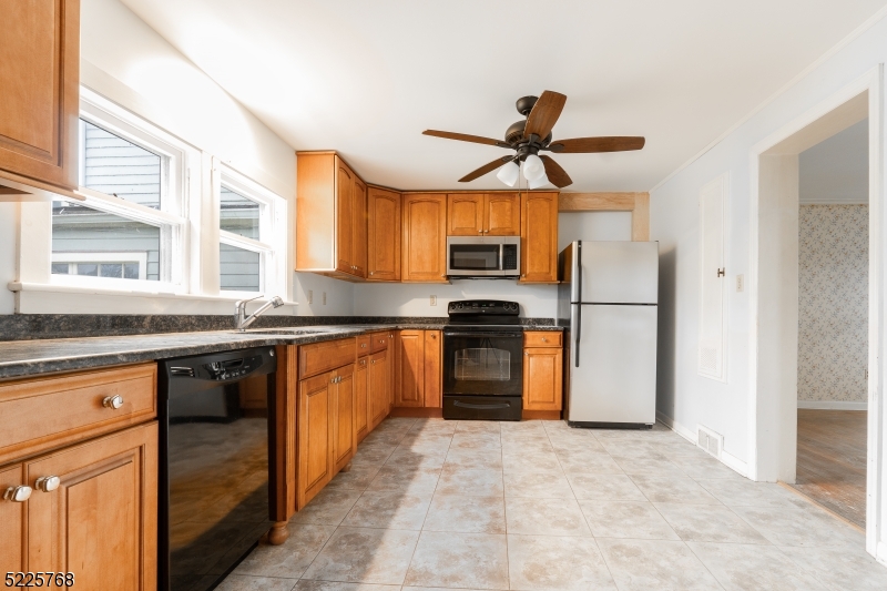 131 Karrville Road Port Murray, NJ 07865 - Photo 6 of 23 a kitchen with stainless steel appliances granite countertop a sink a stove a refrigerator cabinets and a dining table