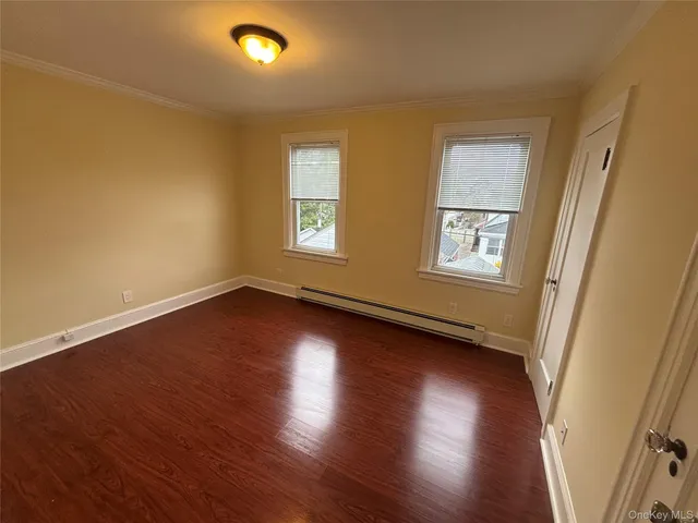 a view of a livingroom with wooden floor and window