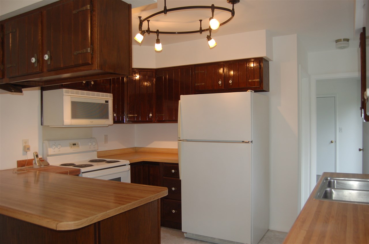 7860 Gurler Road DeKalb, IL 60115 - Photo 6 of 23 a kitchen with a sink a microwave a stove and refrigerator