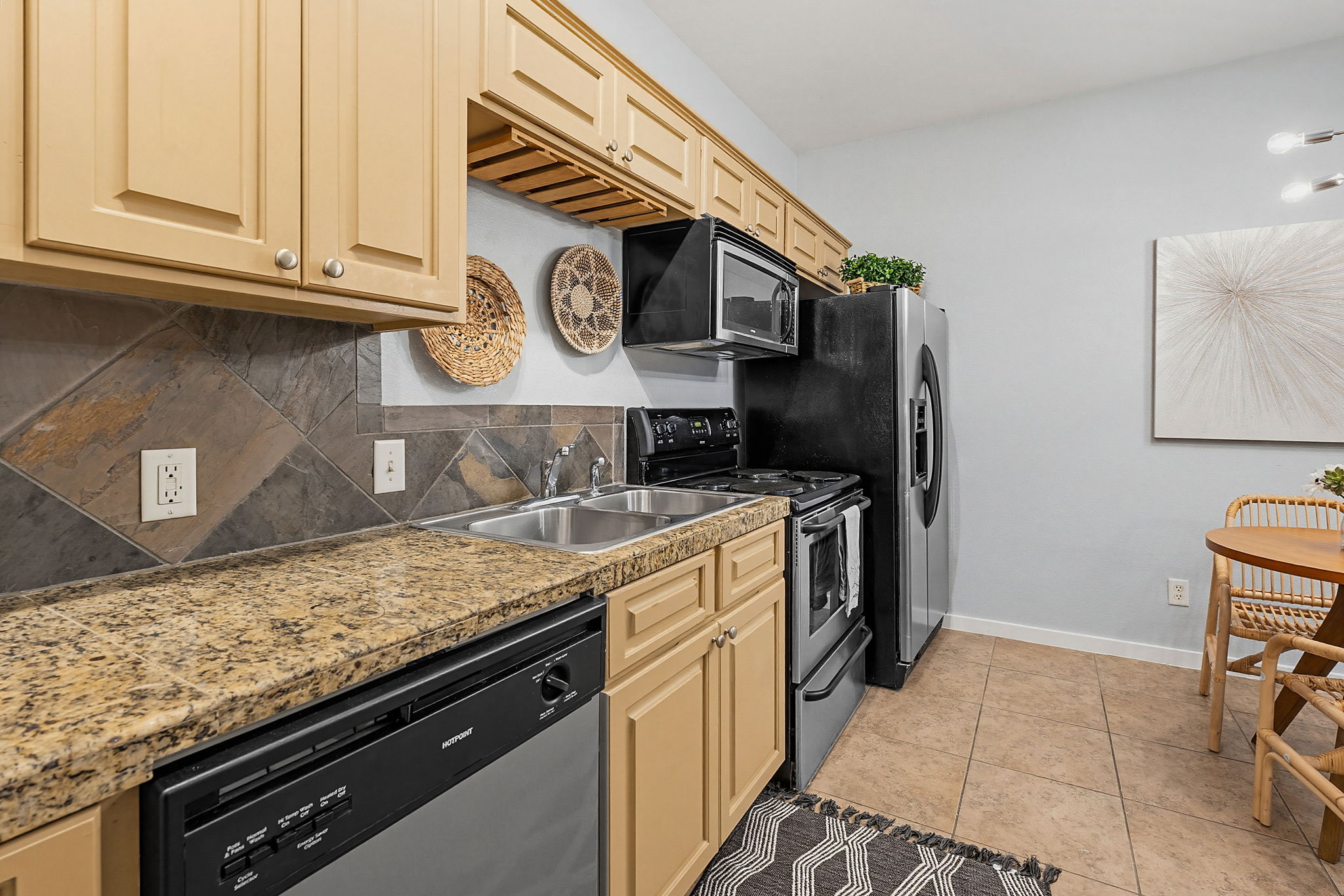 2106 Cullen Avenue, Unit 206 Austin, TX 78757 - Photo 12 of 20 Dishwasher, range, microwave and stainless look refrigerator.