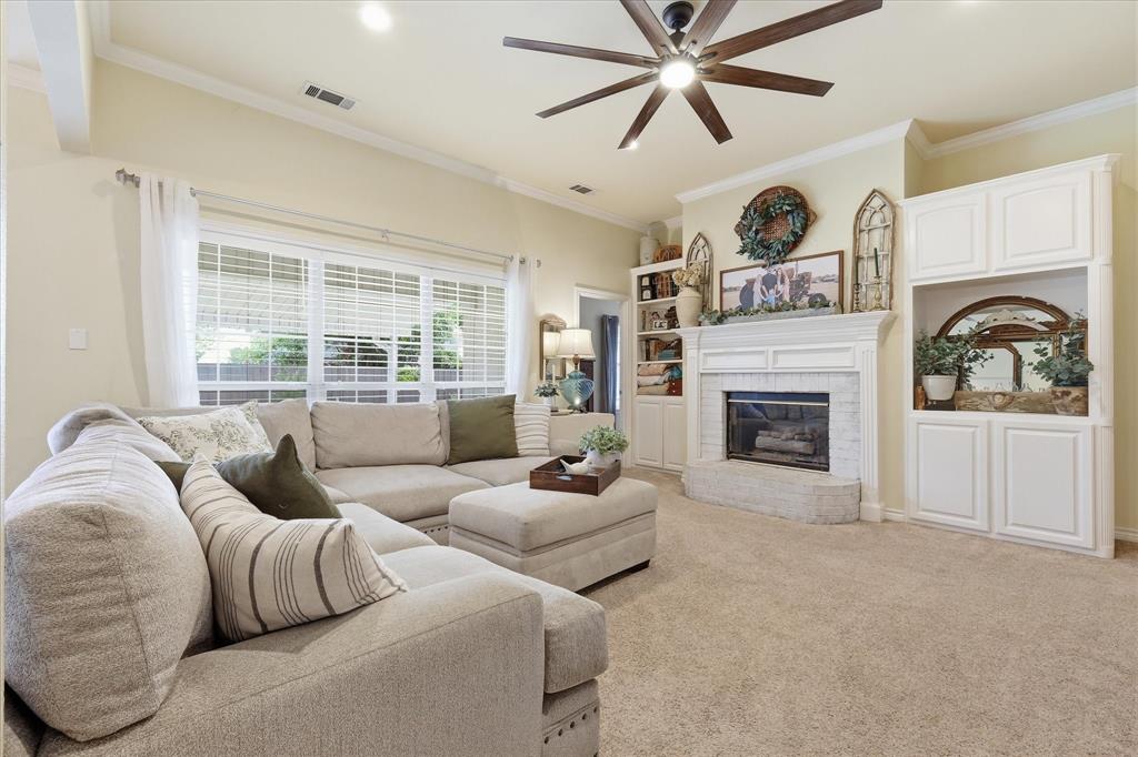 202 Colonial Heights Sanger, TX 76266 - Photo 6 of 27 a living room with furniture and a fireplace