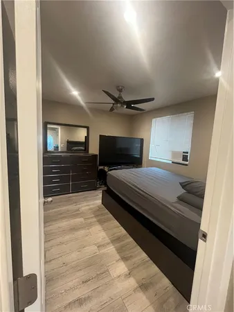 a bedroom with a bed and wooden floor