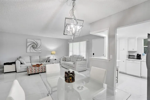 a kitchen with cabinets appliances a sink and a counter top