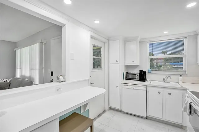 a kitchen with stainless steel appliances a refrigerator and microwave