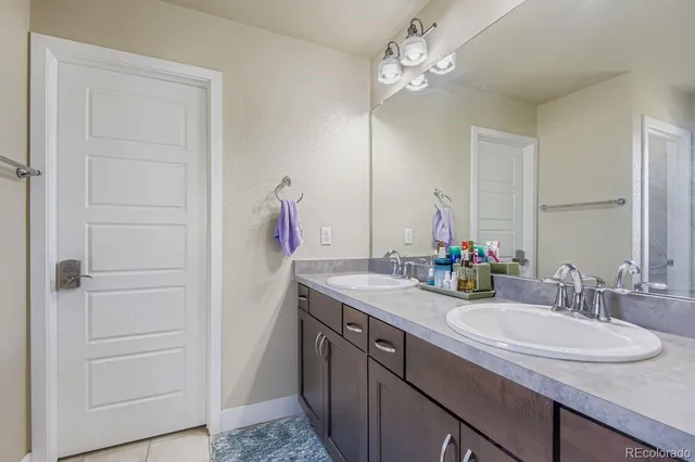 a bathroom with a sink vanity and a mirror