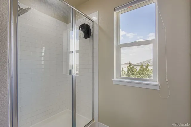 a bathroom with a shower and a mirror