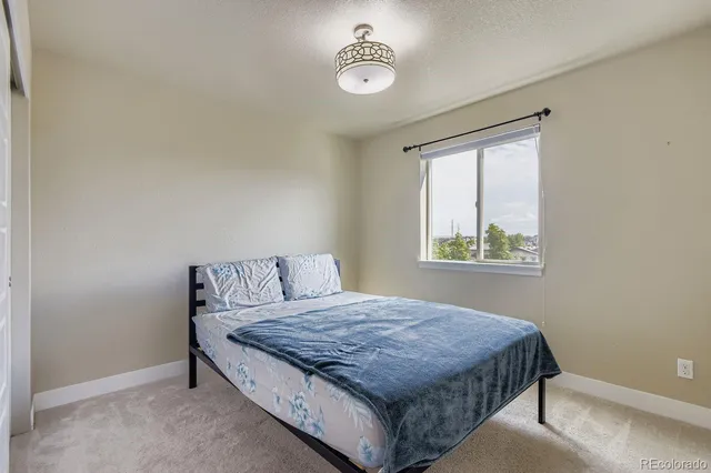 a room with a bed and window