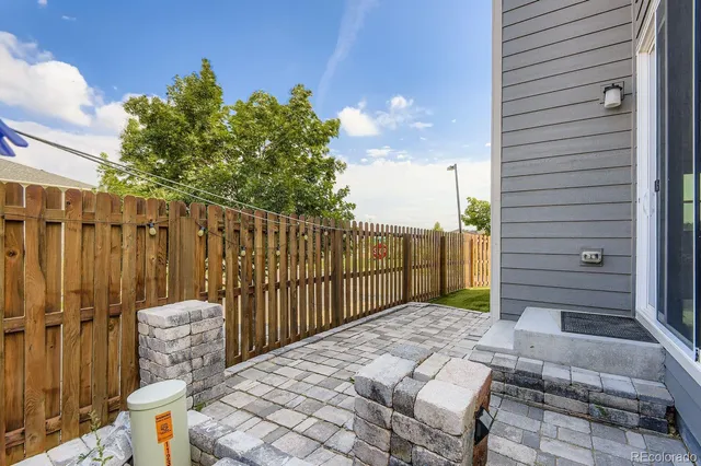 a view of a backyard with wooden fence