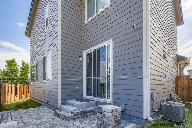 a view of a house with a yard and wooden fence