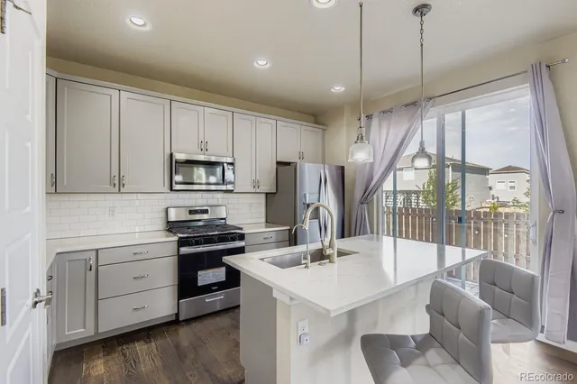 a kitchen with a sink appliances and cabinets