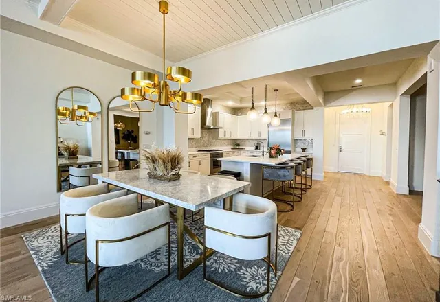 a kitchen with sink and view of living room