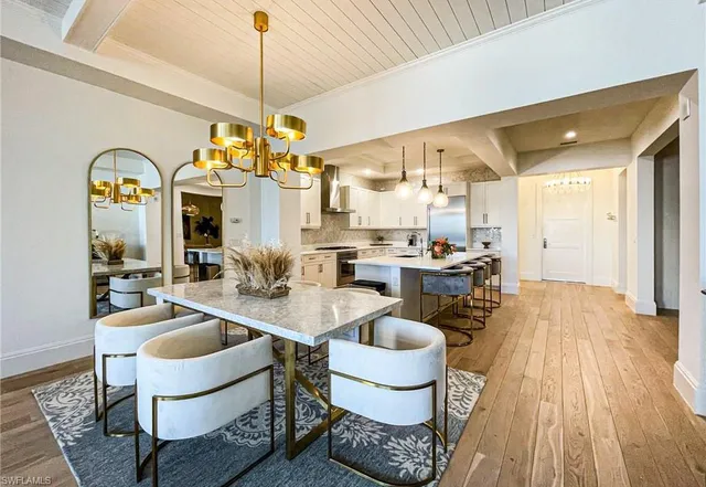 a room with dining table and windows