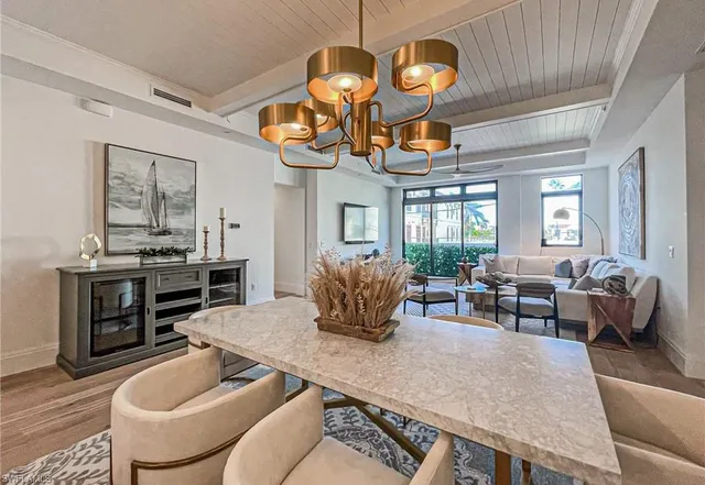 a living room with fireplace furniture and a chandelier