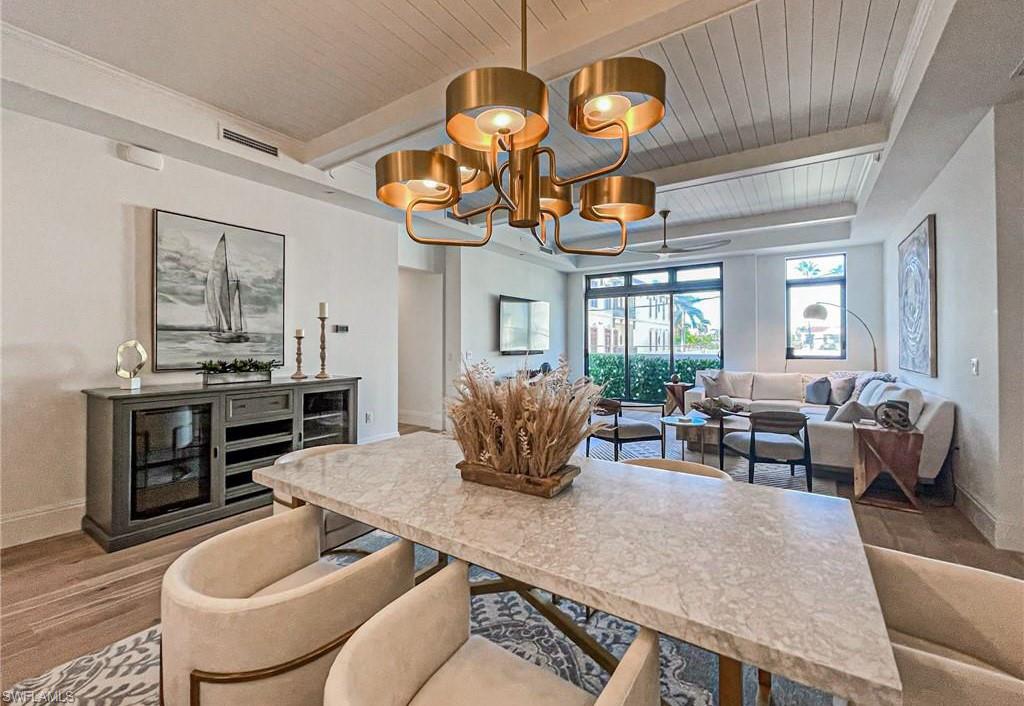 875 6th Avenue South, Unit 204 Naples, FL 34102 - Photo 16 of 29 a living room with fireplace furniture and a chandelier