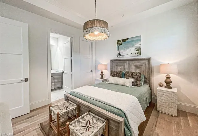a bedroom with a bed and a chandelier