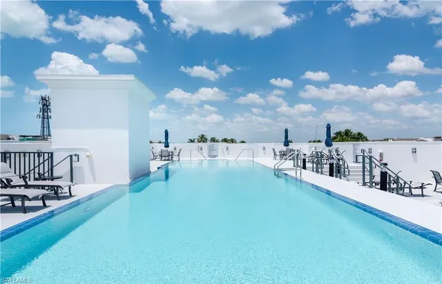 a view of a swimming pool with outdoor seating