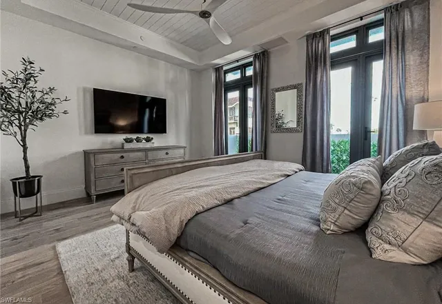 a bedroom with a large bed and a flat screen tv