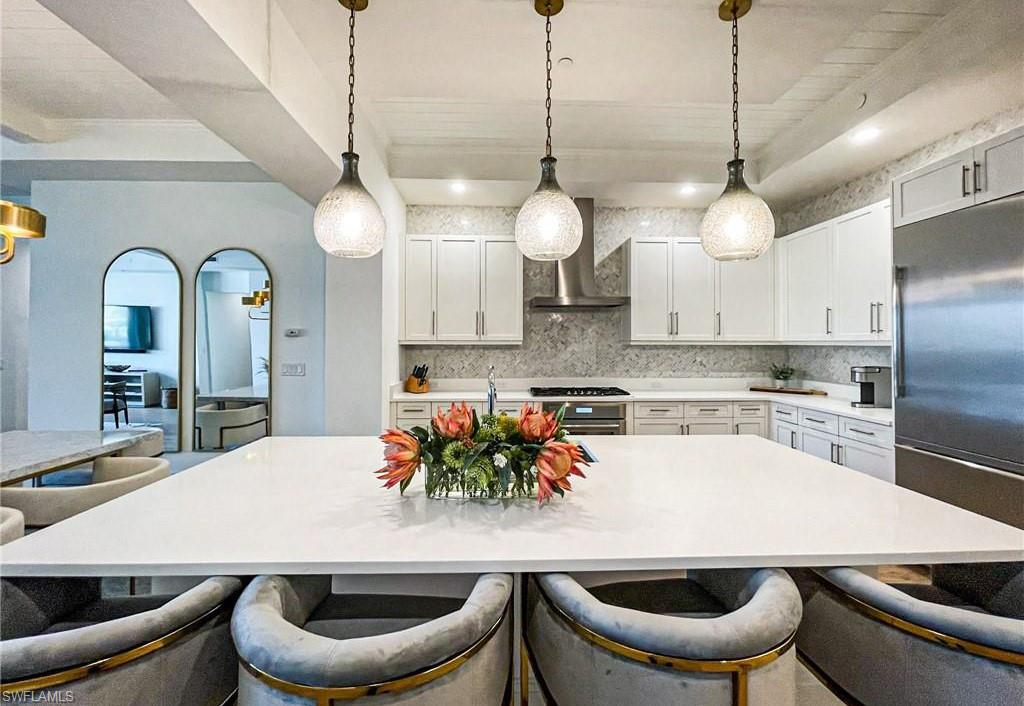 875 6th Avenue South, Unit 204 Naples, FL 34102 - Photo 9 of 29 a kitchen with a dining table and chairs