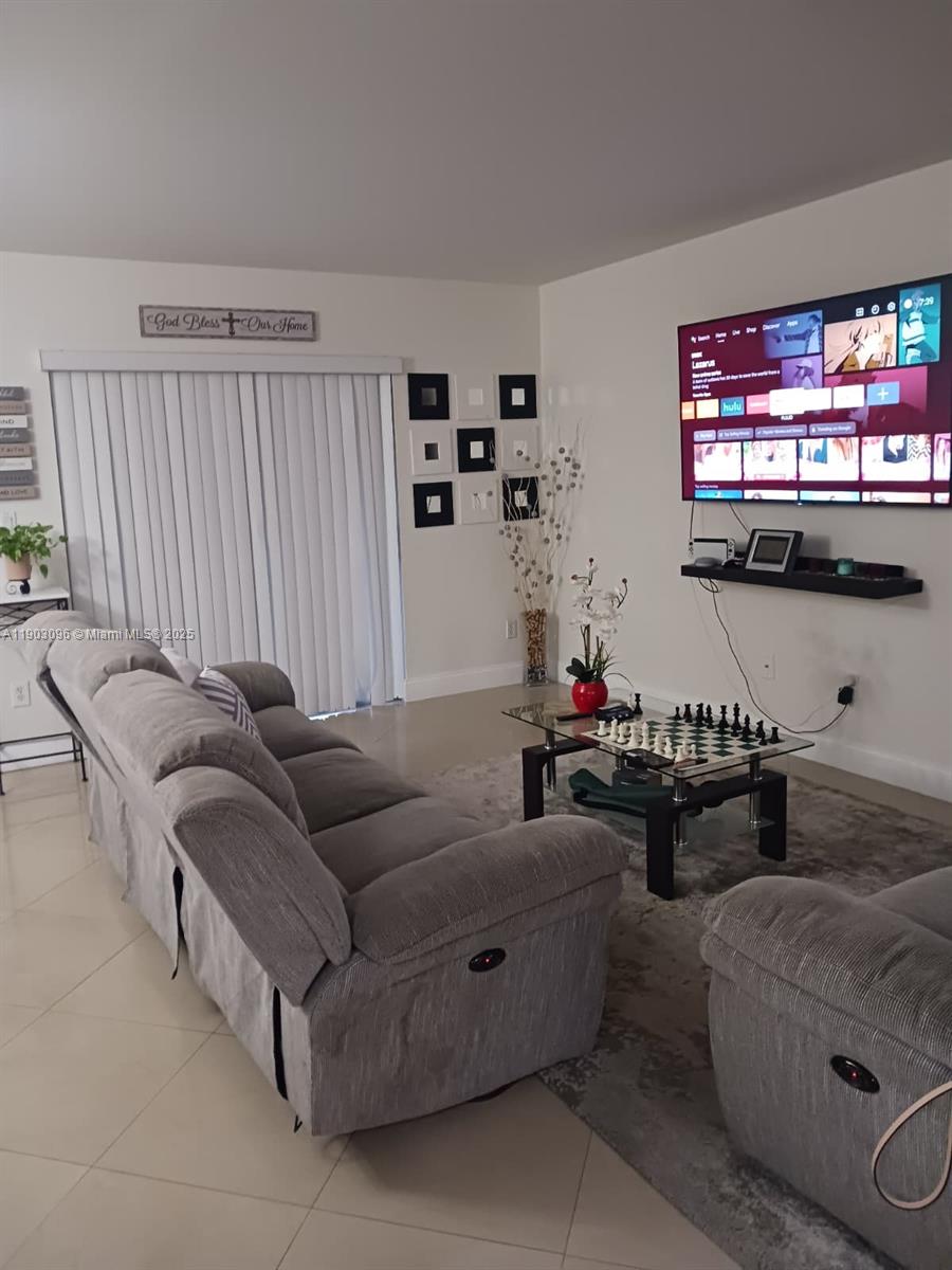 8340 Southwest 154th Avenue, Unit 63 Miami, FL 33193 - Photo 13 of 18 a living room with furniture and a flat screen tv