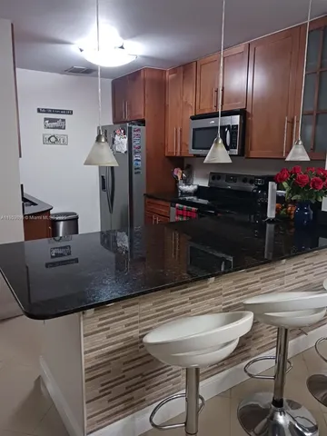 a kitchen with a table and chairs in it