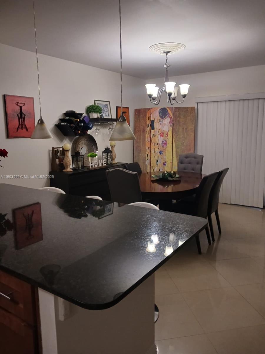 8340 Southwest 154th Avenue, Unit 63 Miami, FL 33193 - Photo 16 of 18 a kitchen with a table and chairs in it