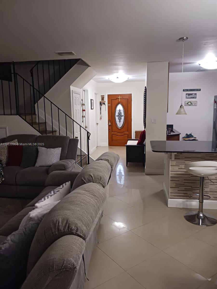 8340 Southwest 154th Avenue, Unit 63 Miami, FL 33193 - Photo 2 of 18 a living room with furniture and a lamp