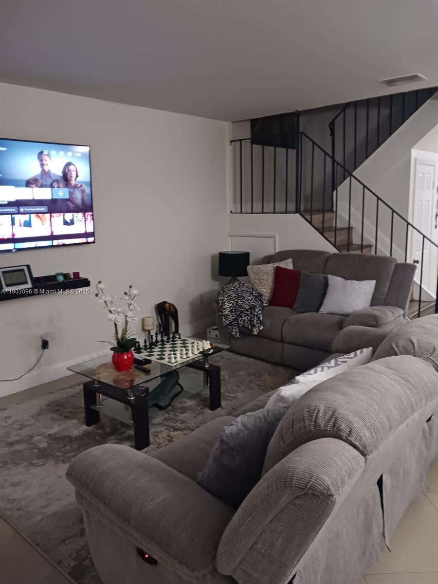 8340 Southwest 154th Avenue, Unit 63 Miami, FL 33193 - Photo 3 of 18 a living room with furniture and a flat screen tv