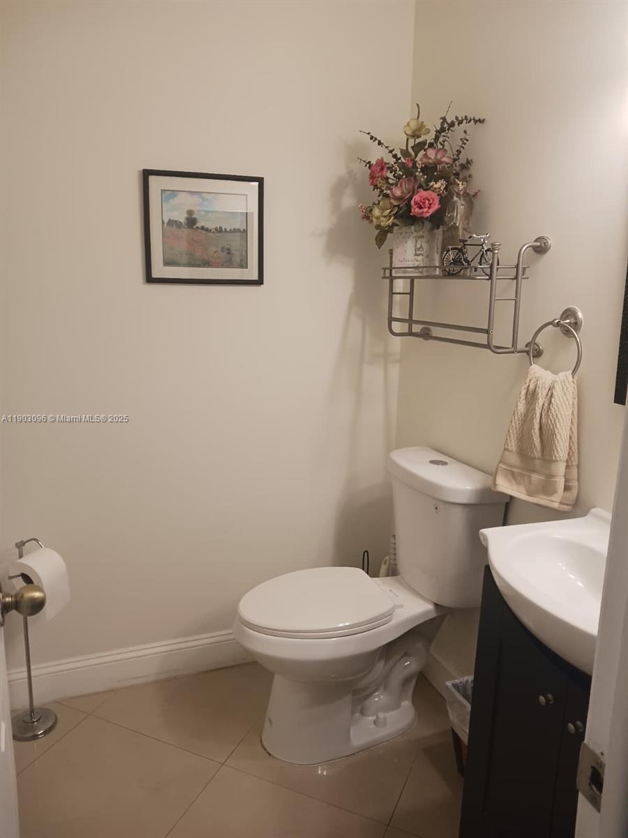 8340 Southwest 154th Avenue, Unit 63 Miami, FL 33193 - Photo 5 of 18 a white toilet sitting next to a bathroom sink