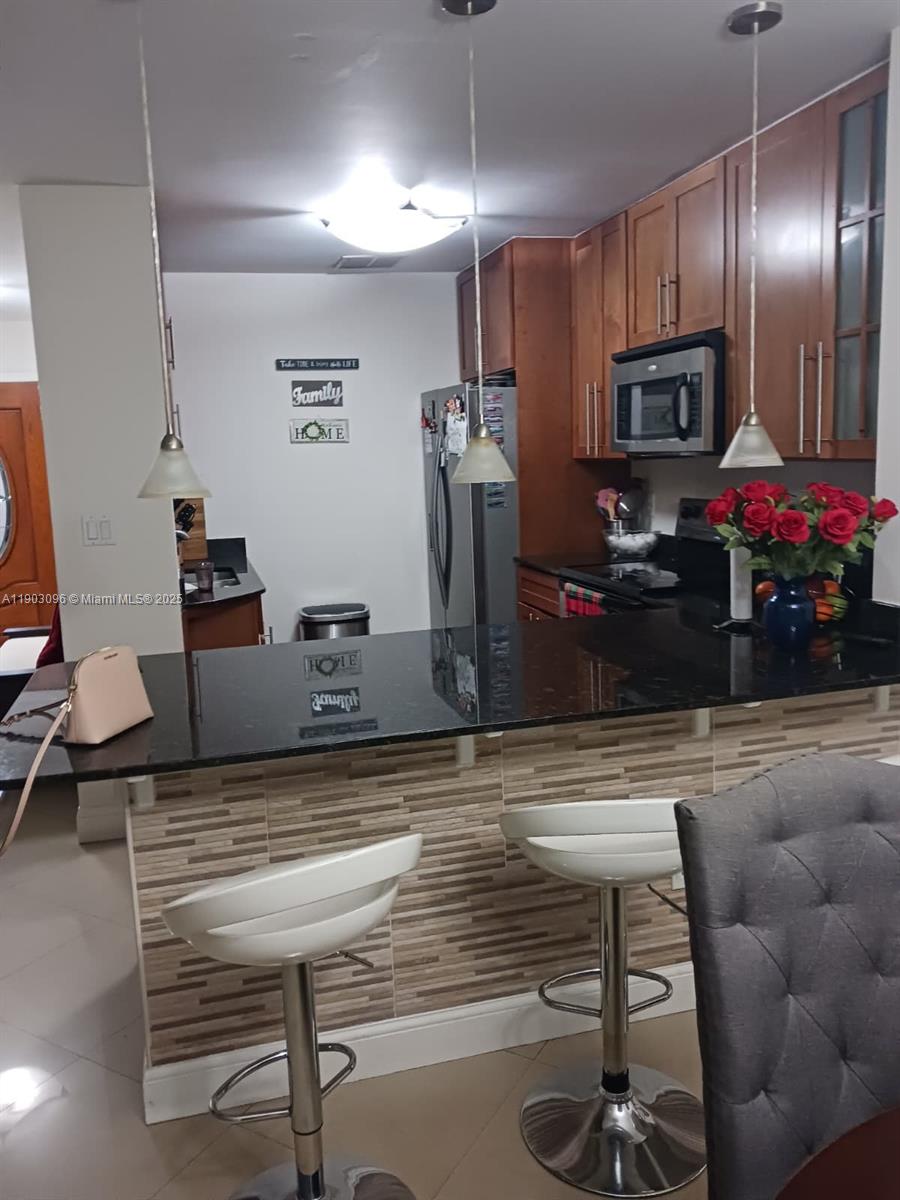 8340 Southwest 154th Avenue, Unit 63 Miami, FL 33193 - Photo 8 of 18 a living room with furniture and a flat screen tv