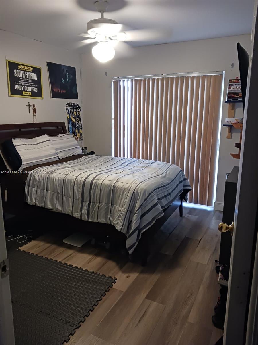 8340 Southwest 154th Avenue, Unit 63 Miami, FL 33193 - Photo 9 of 18 a bedroom with a bed and a mirror on the dresser