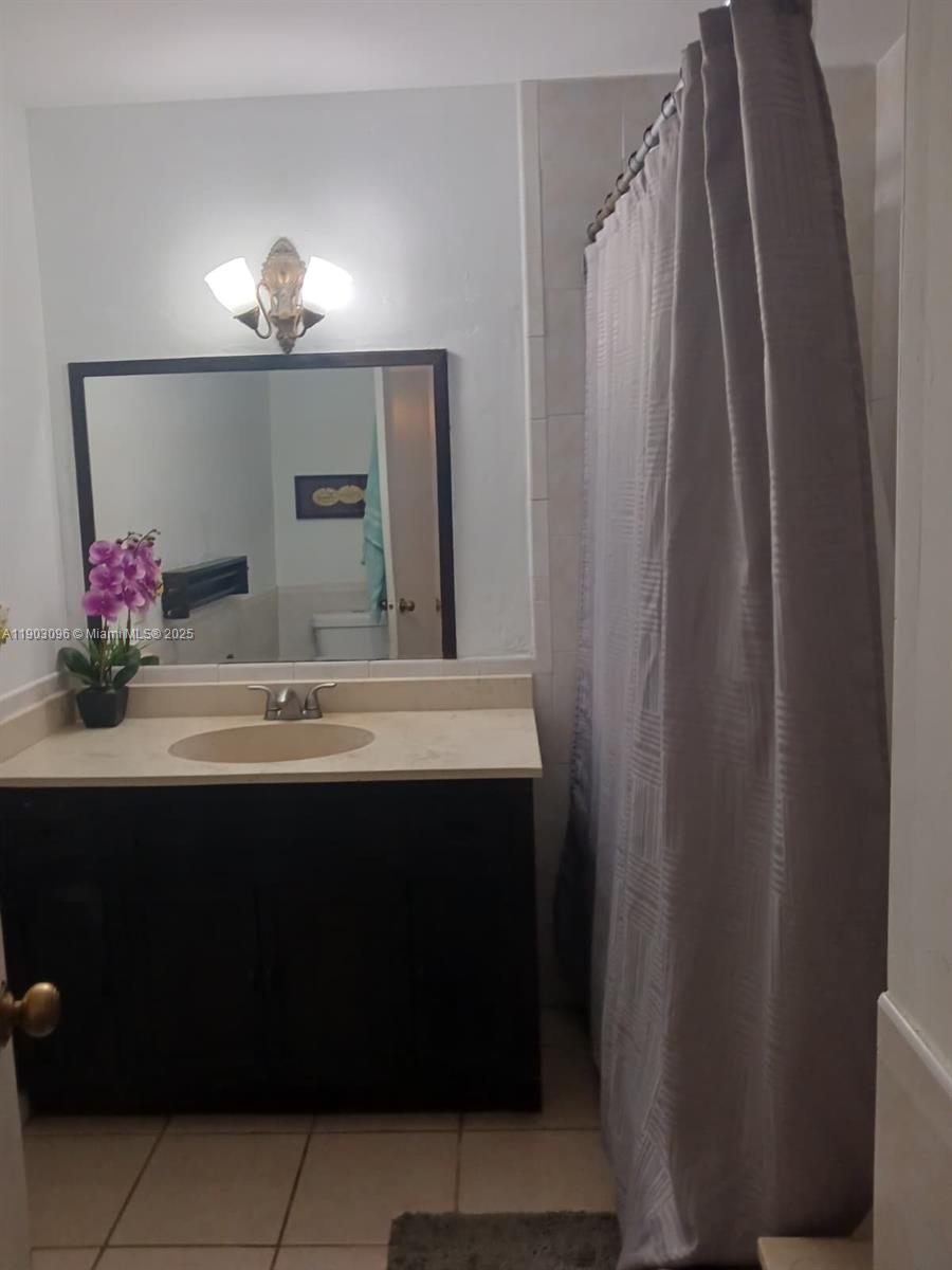 8340 Southwest 154th Avenue, Unit 63 Miami, FL 33193 - Photo 10 of 18 a bathroom with a sink and a mirror