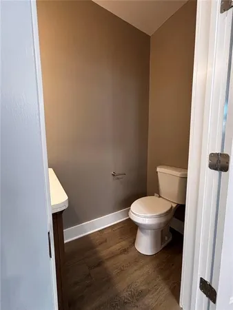 a kitchen with granite countertop wooden floors and white appliances