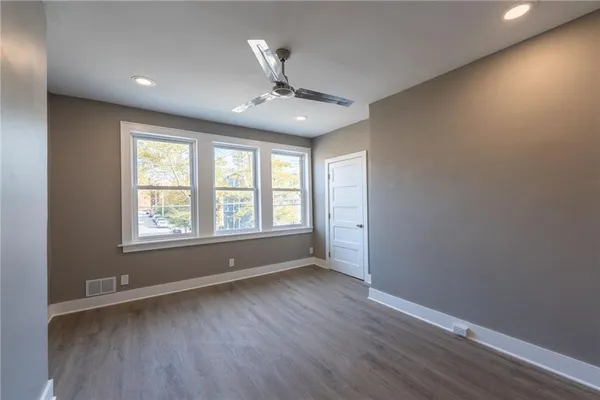 a bedroom with a large bed and a window