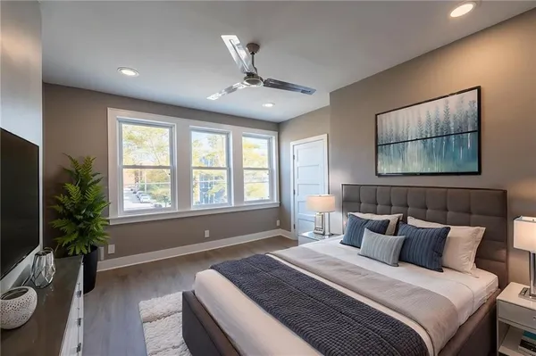 a view of an empty room with wooden floor