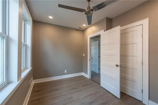 a bathroom with a tub a sink and a large mirror