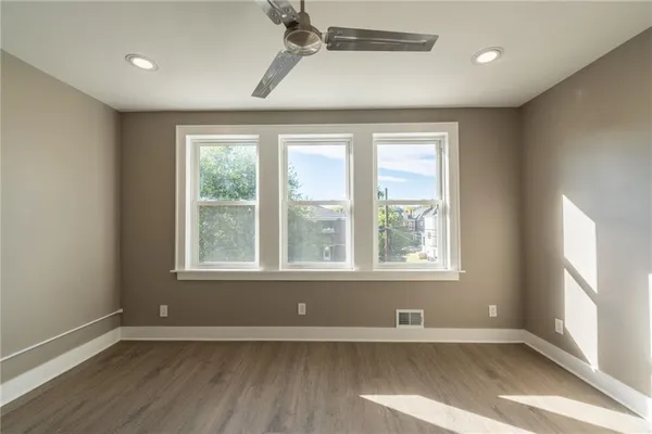 a bedroom with a large bed and a large window