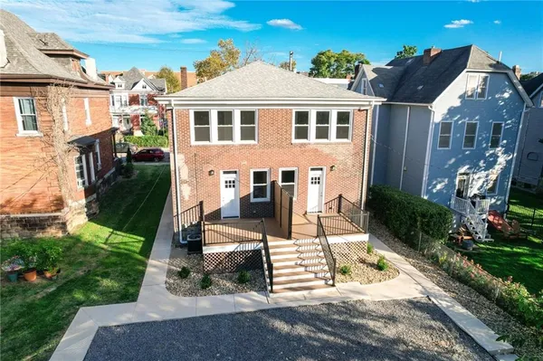 an aerial view of a house with a yard