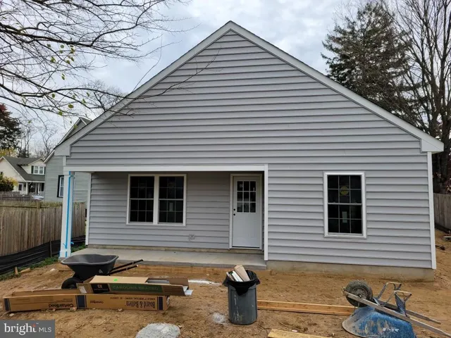 a backyard of a house with barbeque oven table and chairs