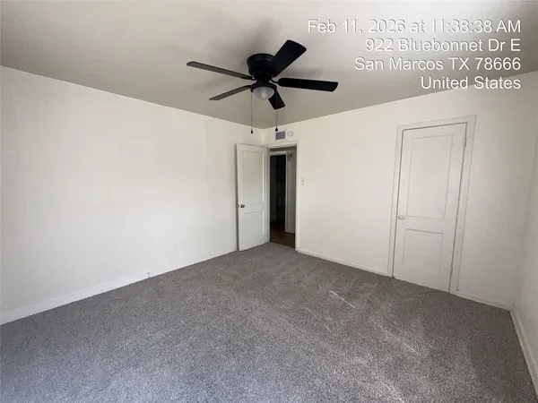 a view of a big room with a ceiling fan