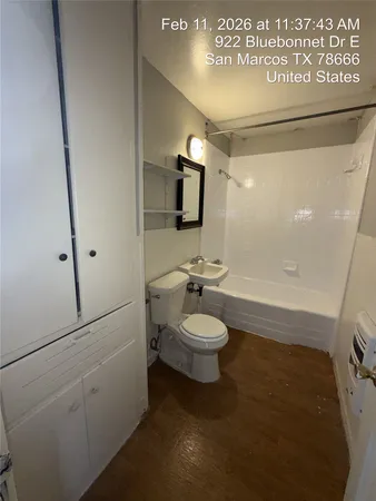 a bathroom with a toilet a sink and mirror