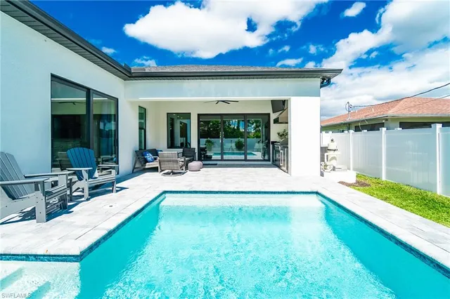 a view of swimming pool with outdoor seating