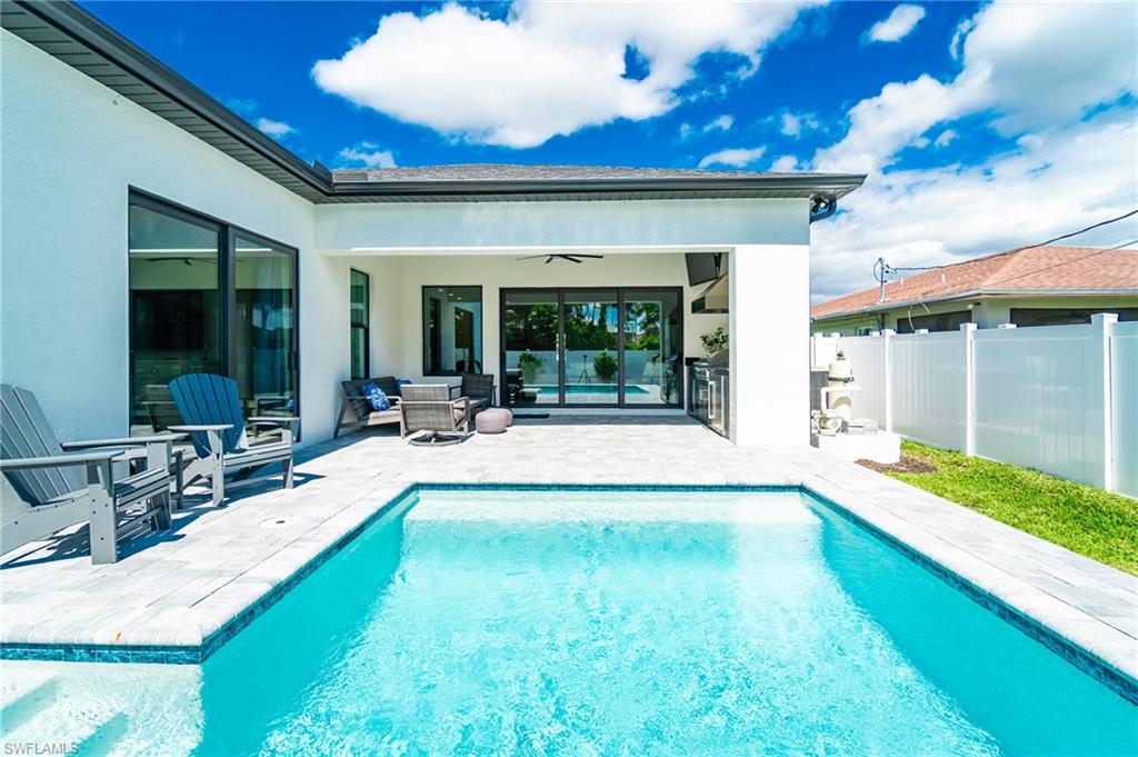a view of swimming pool with outdoor seating