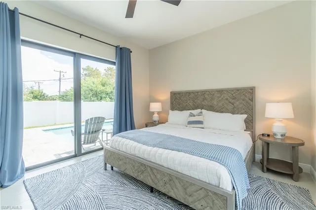 a bedroom with a large bed and a night stand